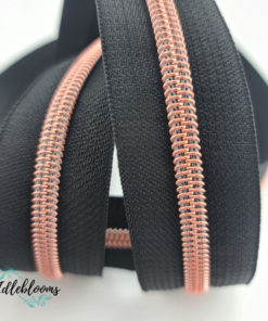 Black zipper with rose gold coil