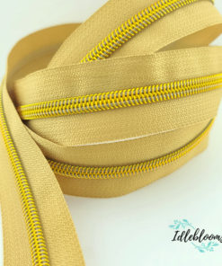 Tan zipper with bright gold coil