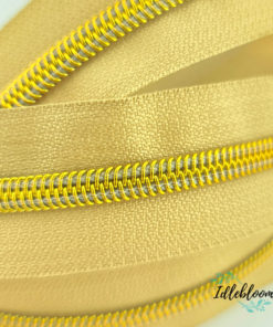 Alternative view of Tan zipper with bright gold coil